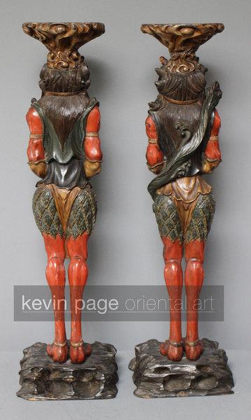 A pair of unusual japanese carved wood candlestick holders in the form of oni