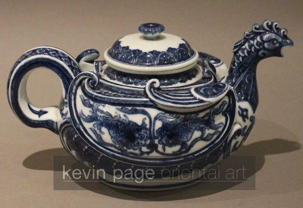 A small blue and white Japanese teapot in the form of a chicken