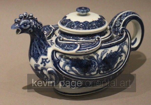 A small blue and white Japanese teapot in the form of a chicken