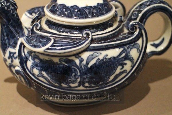 A small blue and white Japanese teapot in the form of a chicken