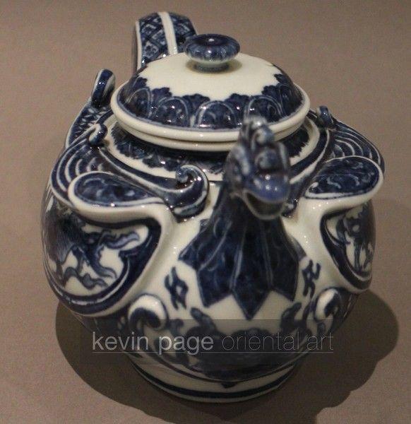 A small blue and white Japanese teapot in the form of a chicken
