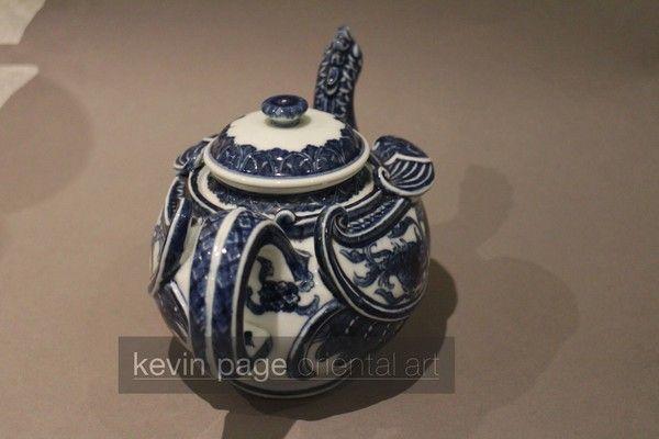 A small blue and white Japanese teapot in the form of a chicken