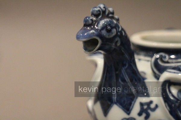 A small blue and white Japanese teapot in the form of a chicken