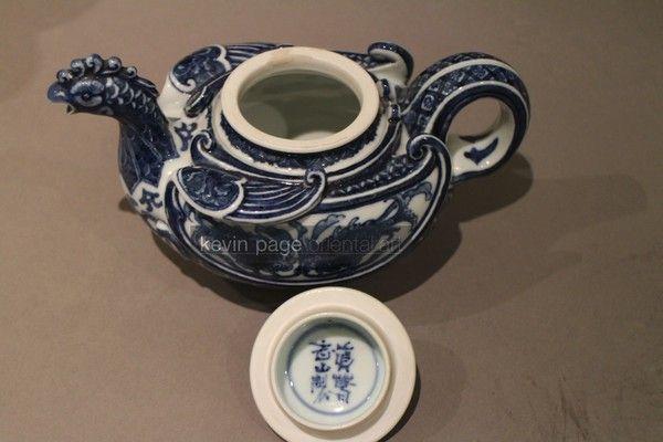 A small blue and white Japanese teapot in the form of a chicken