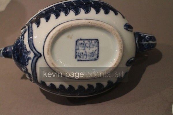 A small blue and white Japanese teapot in the form of a chicken