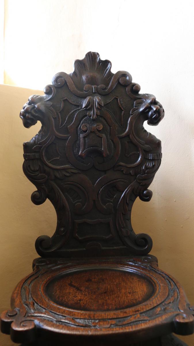 Pair of mid 17th century oak scabelli chairs with scroll work leaf detail and paw feet