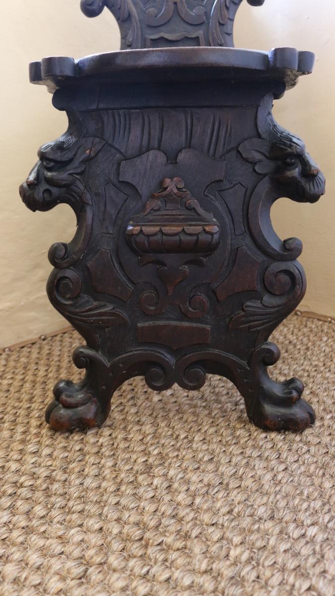 Pair of mid 17th century oak scabelli chairs with scroll work leaf detail and paw feet
