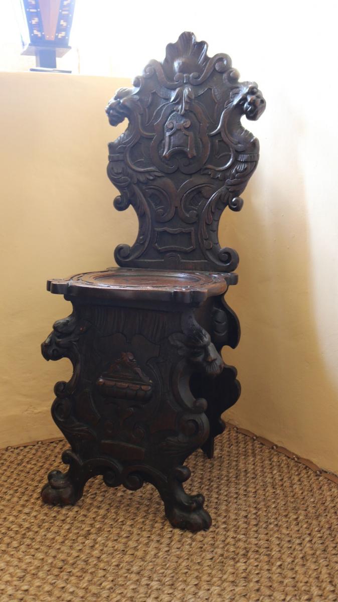 Pair of mid 17th century oak scabelli chairs with scroll work leaf detail and paw feet