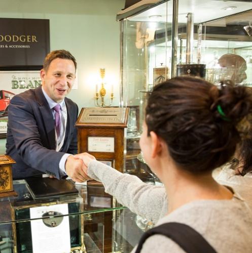 A dealer shakes hand with a client