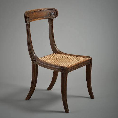 A Regency oak and ebonised chair with caned seat, circa 1810.